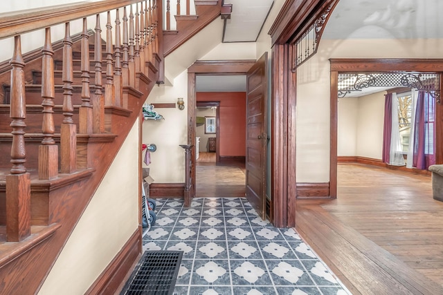 staircase featuring hardwood / wood-style flooring and baseboards