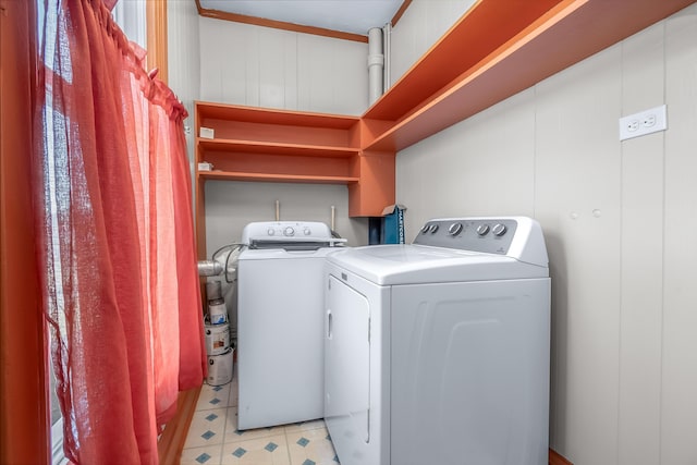 laundry area with laundry area, independent washer and dryer, and light floors