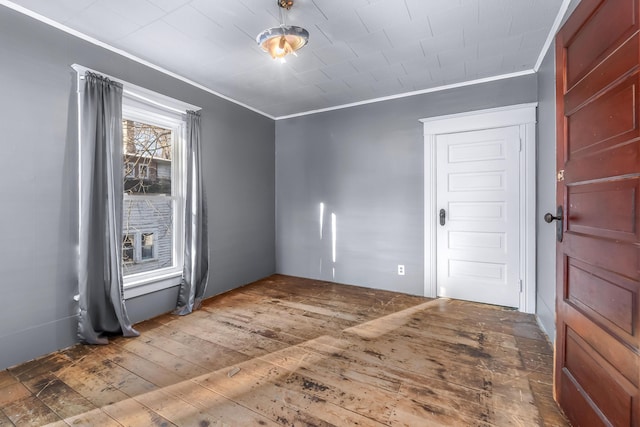 spare room with hardwood / wood-style flooring and ornamental molding