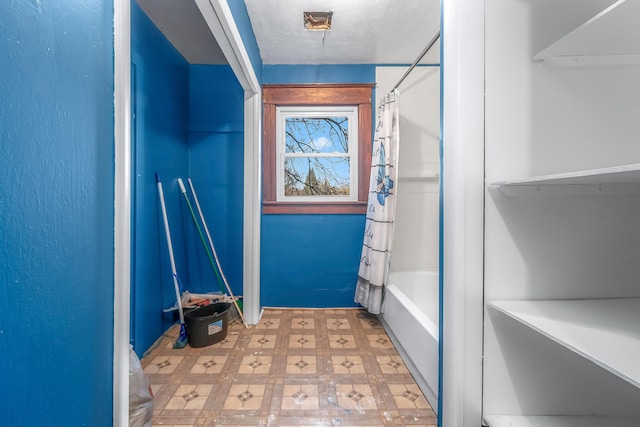 bathroom featuring tile patterned floors, a textured ceiling, and shower / bath combo