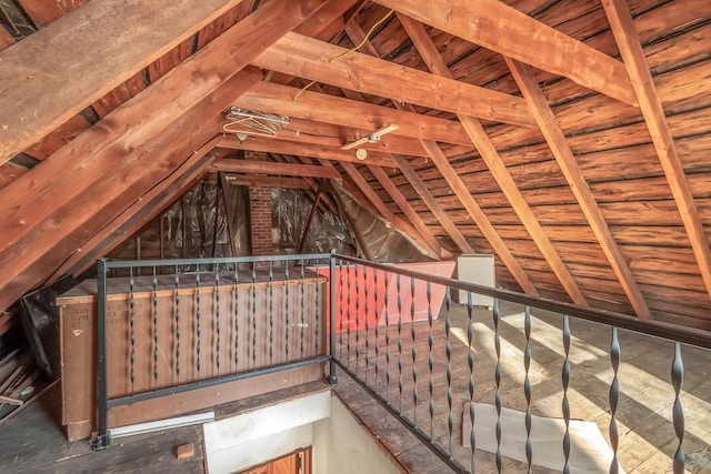 unfinished attic featuring an upstairs landing