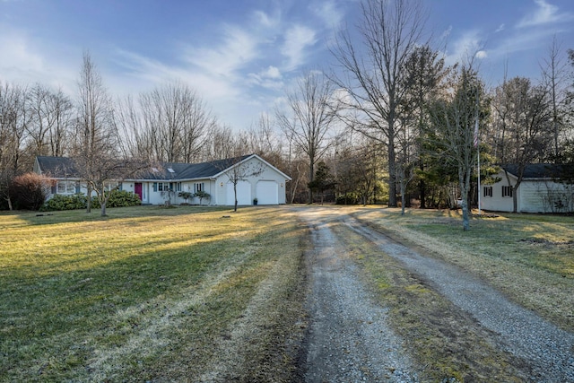 exterior space with a garage, a front lawn, and driveway