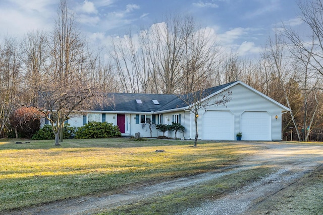 single story home with a garage, a front lawn, and driveway