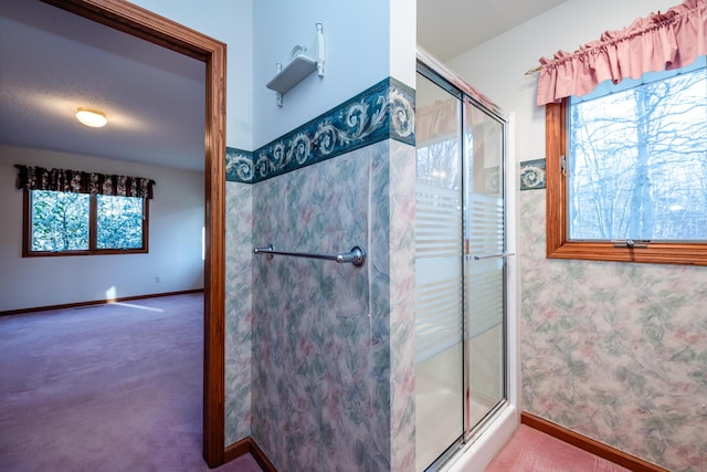 full bath featuring baseboards and a stall shower