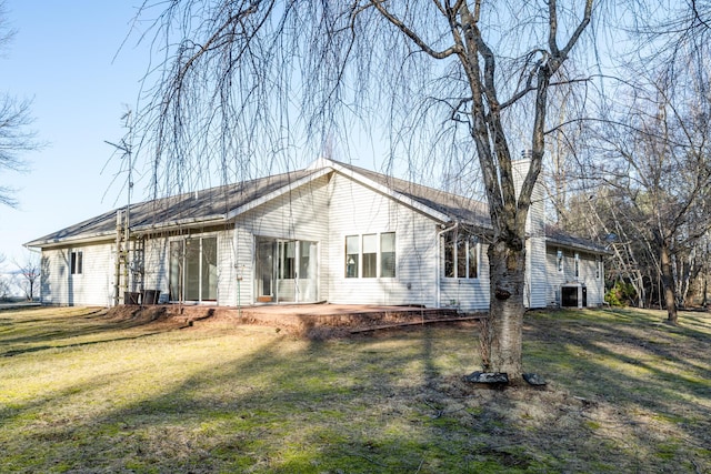 back of house featuring a patio and a lawn