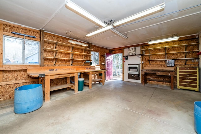 garage with a workshop area and heating unit