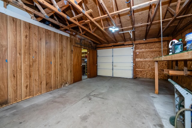 garage featuring wood walls