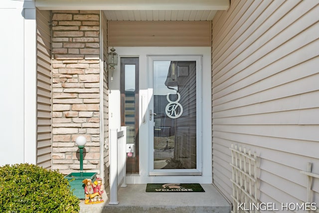 view of exterior entry featuring stone siding