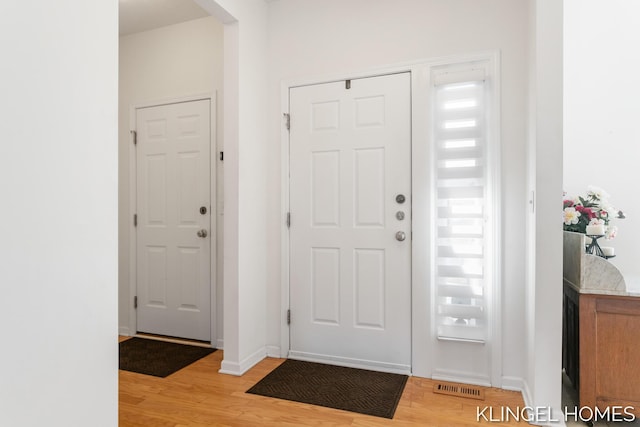 entryway with visible vents, baseboards, and light wood-style floors