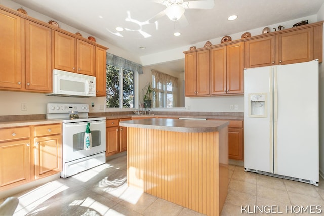 kitchen featuring a center island, light tile patterned floors, recessed lighting, white appliances, and a sink