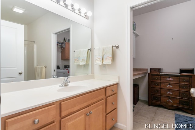 bathroom with vanity, tile patterned floors, and washing machine and clothes dryer