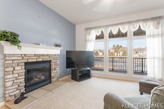 living area with a brick fireplace, baseboards, carpet, and vaulted ceiling