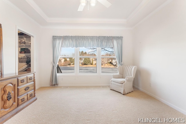 sitting room featuring a raised ceiling, crown molding, baseboards, and carpet floors