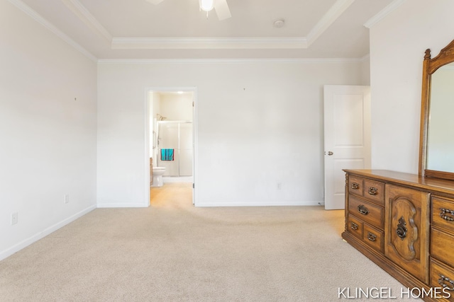 bedroom featuring light carpet, baseboards, a tray ceiling, and ornamental molding