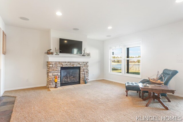 sitting room with recessed lighting, baseboards, a stone fireplace, and carpet flooring