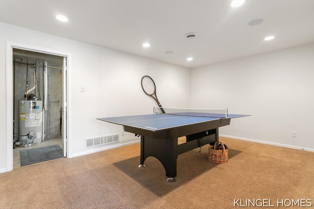 playroom with gas water heater, visible vents, and carpet flooring