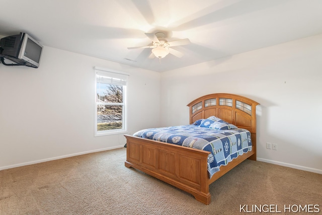 bedroom with a ceiling fan, baseboards, and light carpet