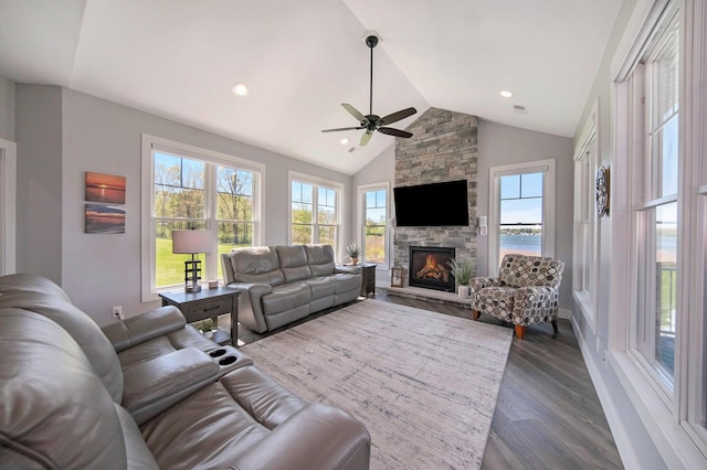 living room featuring high vaulted ceiling, dark wood-type flooring, recessed lighting, a fireplace, and ceiling fan