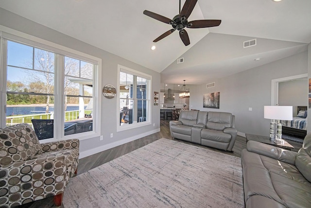 living room with ceiling fan with notable chandelier, recessed lighting, wood finished floors, and visible vents