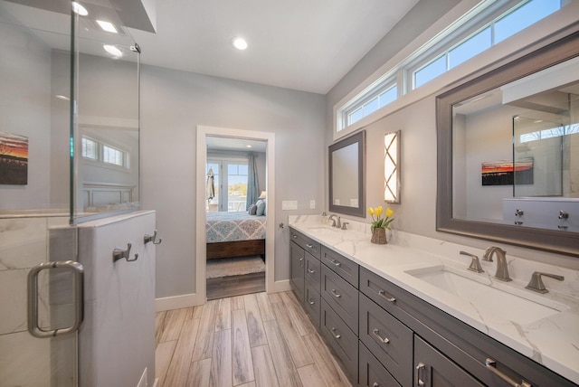 full bath with ensuite bath, a stall shower, wood finished floors, and a sink