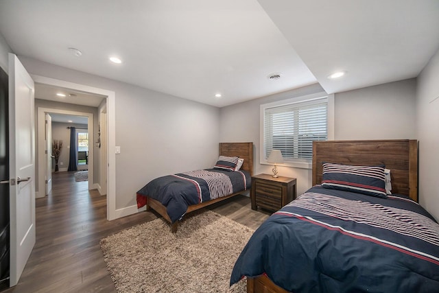 bedroom with visible vents, recessed lighting, baseboards, and wood finished floors