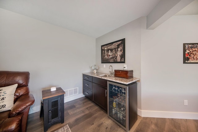 bar featuring visible vents, a sink, dark wood-style floors, wine cooler, and wet bar