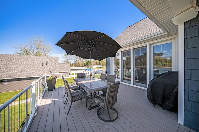 wooden deck with area for grilling and outdoor dining area