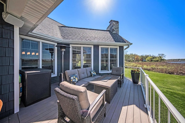 wooden terrace with an outdoor living space and a lawn