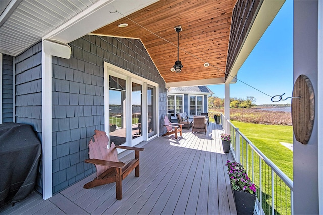 wooden terrace featuring a lawn and area for grilling