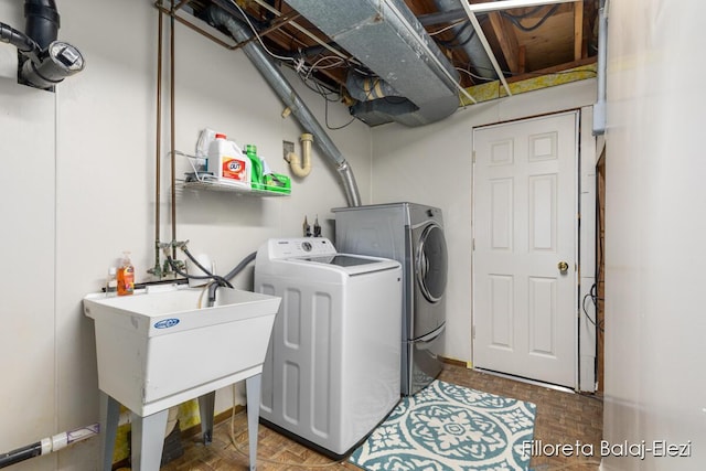 washroom with independent washer and dryer and laundry area