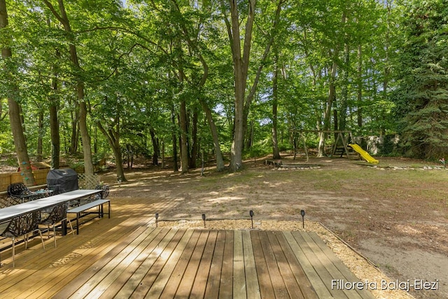 wooden terrace with grilling area and a playground