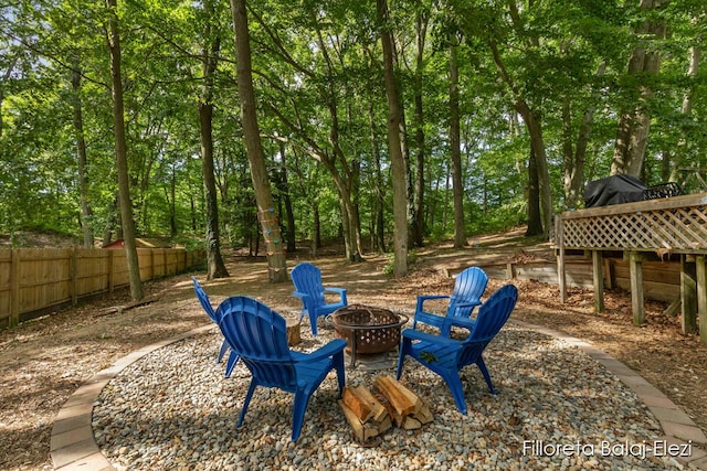 view of yard with an outdoor fire pit and fence