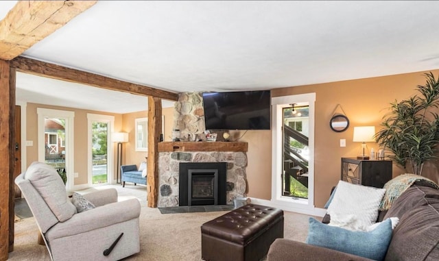 carpeted living area with beam ceiling, a fireplace, and baseboards