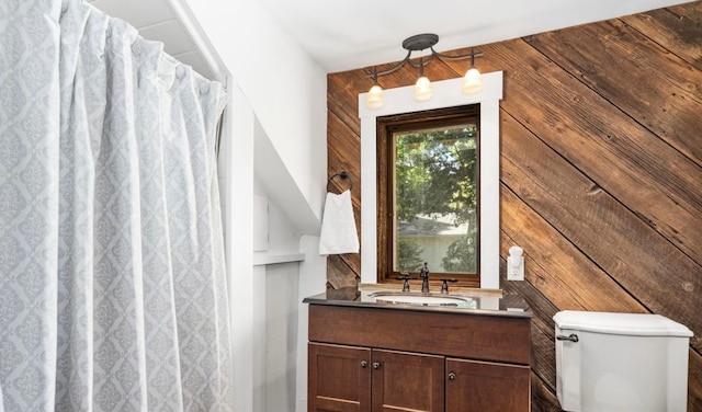 full bath with wooden walls, toilet, vanity, and a shower with shower curtain