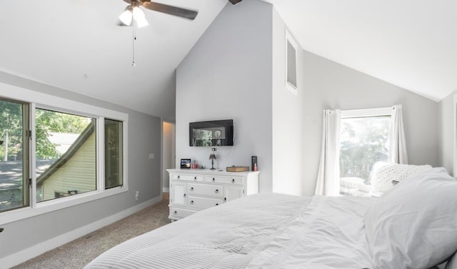 carpeted bedroom with ceiling fan, high vaulted ceiling, and baseboards