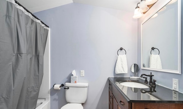 bathroom featuring toilet, vanity, shower / tub combo, and vaulted ceiling