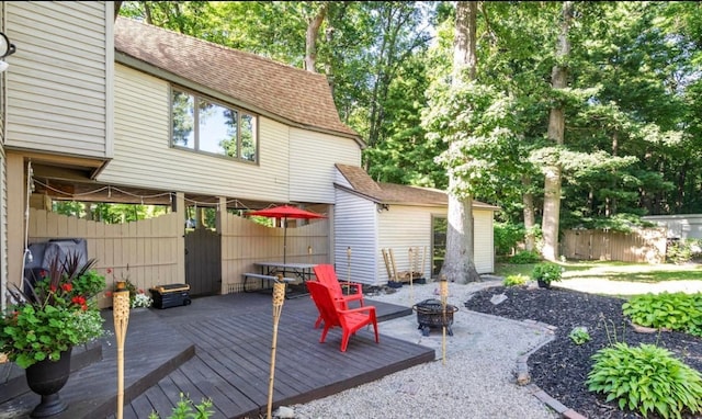 view of patio with a fire pit, fence, and a wooden deck