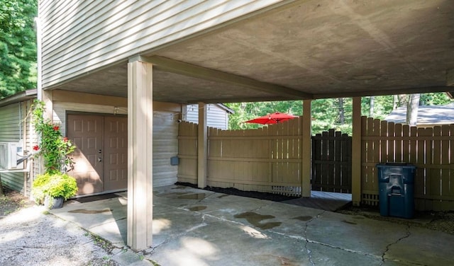 view of patio featuring a carport and fence