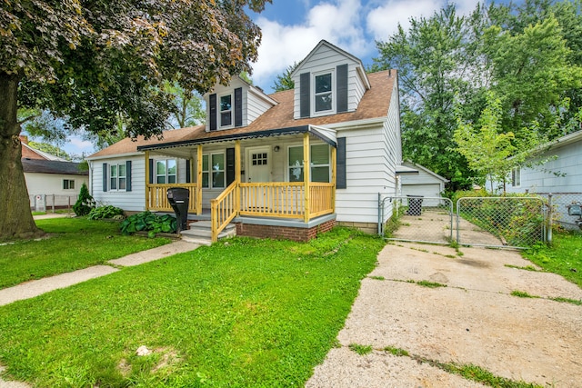 view of front of home featuring a front yard, a gate, fence, roof with shingles, and a porch