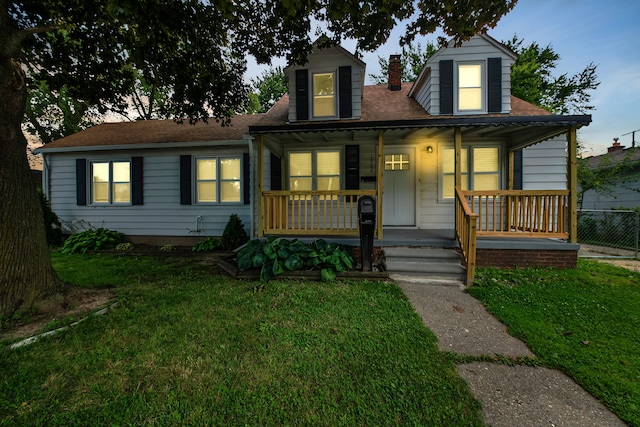 view of front of property featuring a front lawn, fence, covered porch, and a chimney