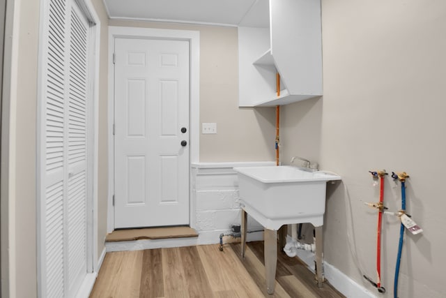 washroom featuring washer hookup, laundry area, and light wood finished floors