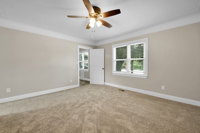 spare room with visible vents, baseboards, carpet, and ceiling fan