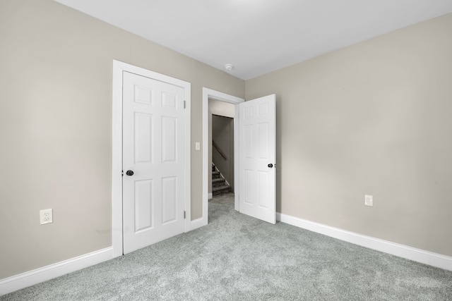 unfurnished bedroom with baseboards and carpet floors