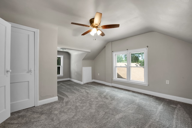 additional living space with baseboards, lofted ceiling, ceiling fan, and carpet flooring