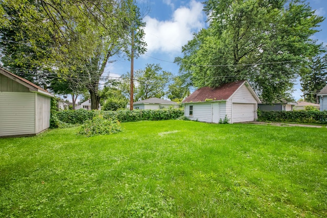 view of yard with an outdoor structure and a garage