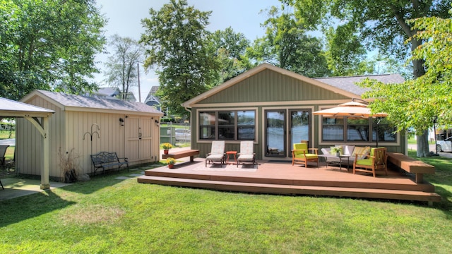 back of house featuring a lawn, a deck, an outdoor living space, a storage shed, and an outdoor structure