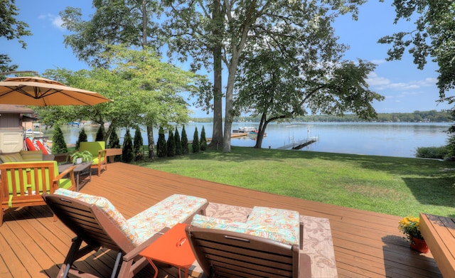 wooden terrace featuring a lawn and a water view