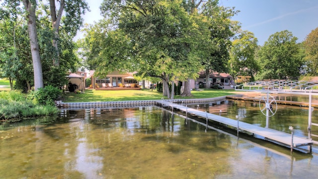 view of dock featuring a water view and a lawn