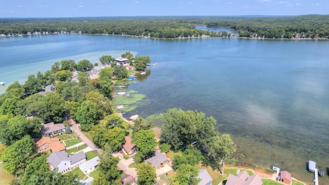 bird's eye view featuring a forest view, a water view, and a residential view