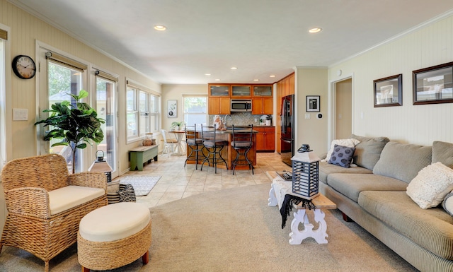 living area featuring recessed lighting, light carpet, light tile patterned flooring, and crown molding